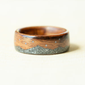 Wooden ring with a metallic inlay on a light background
