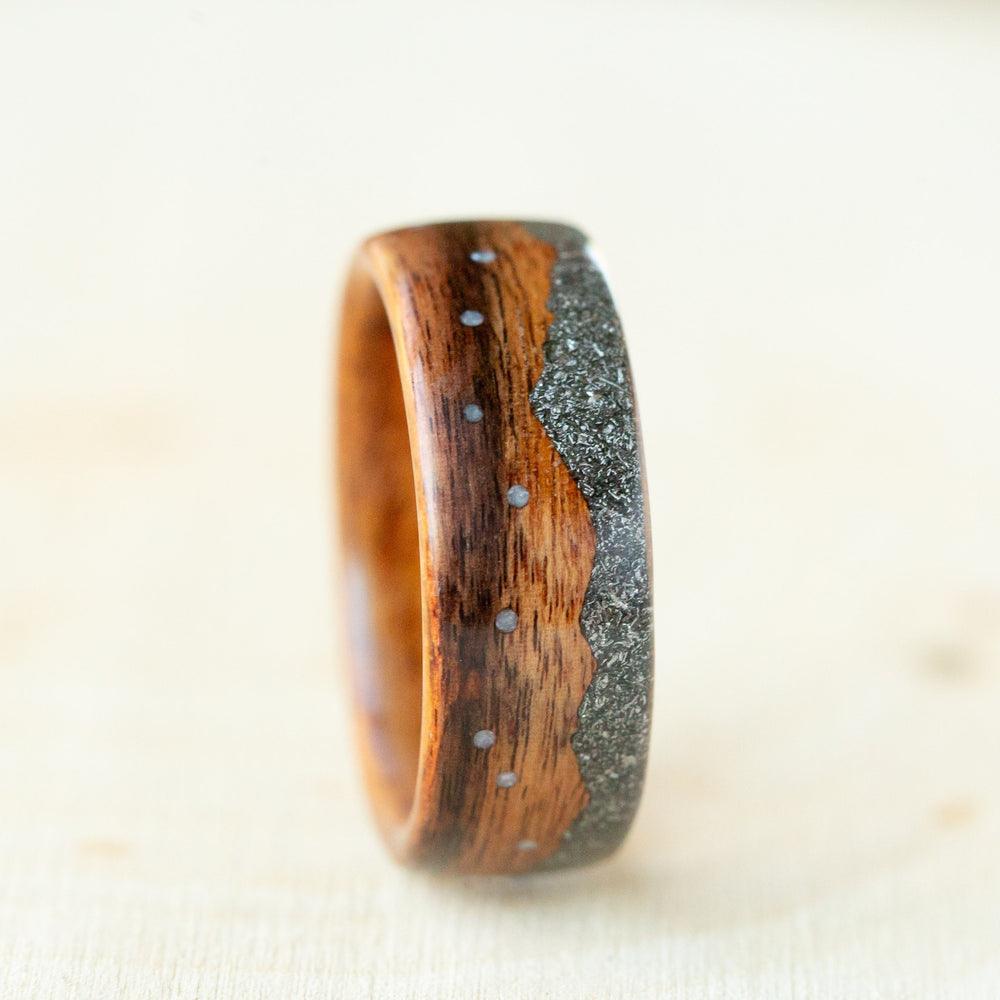 Wooden ring with a metallic inlay on a light background