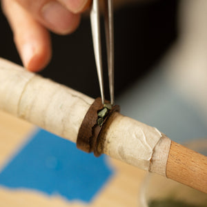 black wood ring being inlaid
