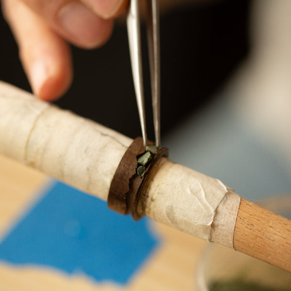 black wood ring being inlaid